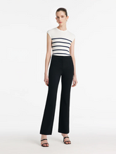 a lady in a black micro-flared pants with a striped top